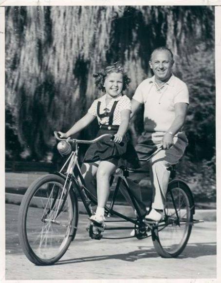 Shirley Temple and her Father George on a Tandem